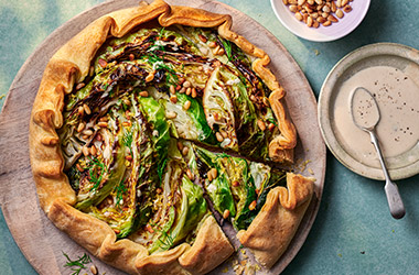 Charred cabbage galette with roasted garlic and tahini