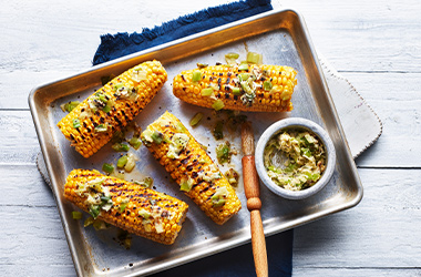 Corn on the cob with charred spring onion butter