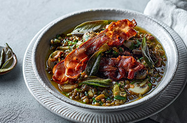 Green lentil stew with bacon and sage