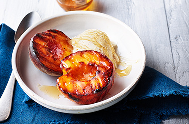 Honey-glazed peaches with vanilla ice cream
