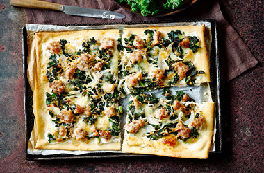 Sausage and kale pizzas