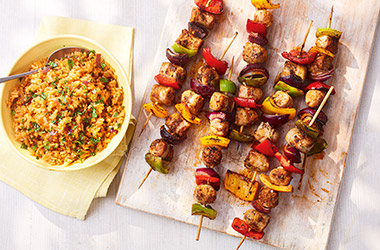 Smoky sausage skewers with tomato rice