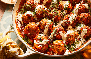 Nargisse Benkabbou's spiced chicken meatballs with garlic tomato sauce and tahini yogurt drizzle