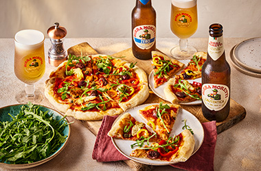 Vegan pizza with peppers, artichokes and olives