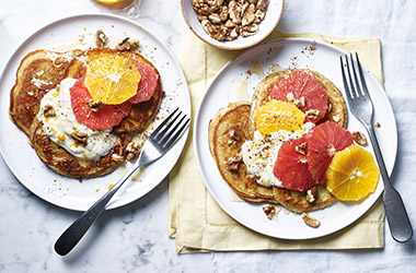 Yogurt and honey pancakes with citrus fruit