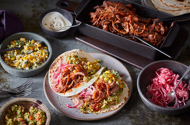Sticky brisket tacos with guacamole, pickled red onions and Mexican street-style corn