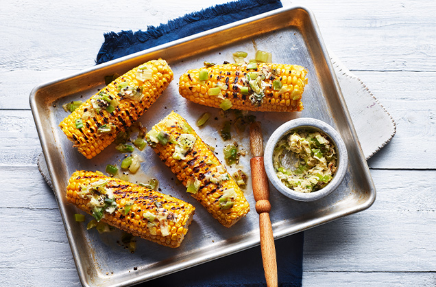 Corn on the cob with charred spring onion butter