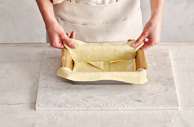 Line the tin with the pastry