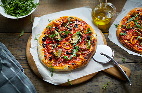 Vegan pizza with peppers, artichokes and olives